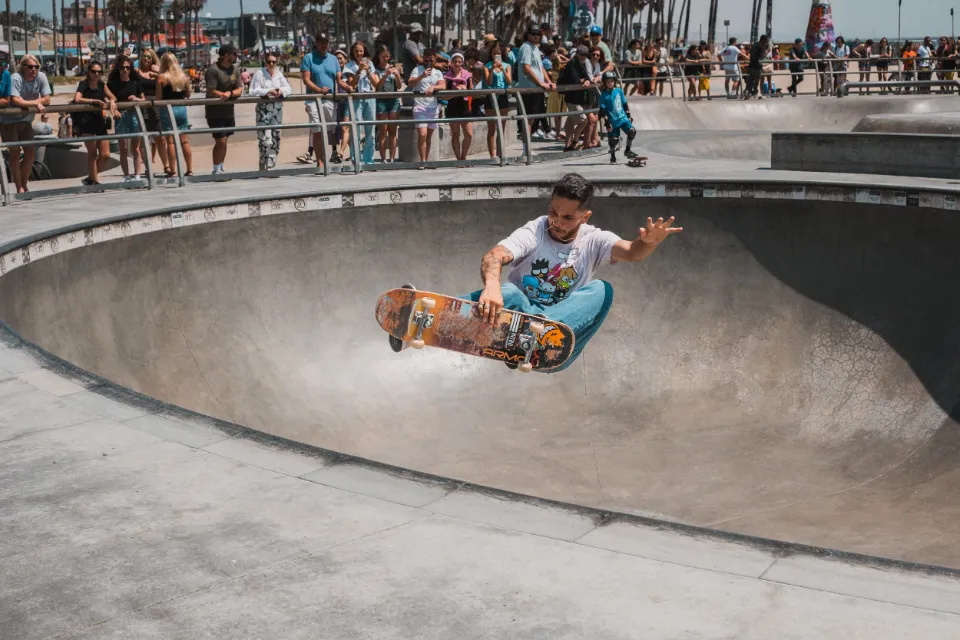 Skateboarder catching air in a skate bowl